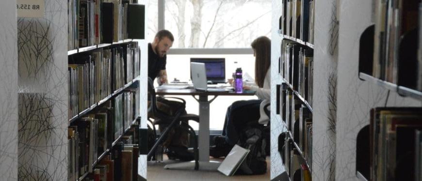 two students studying at table in QC 图书馆 3-9-16